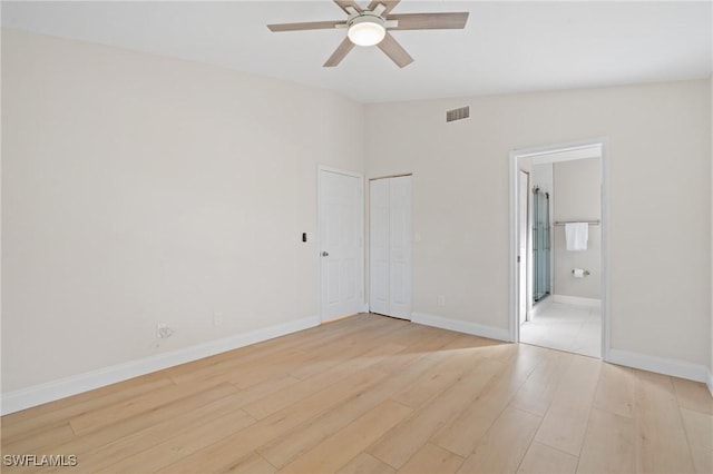 empty room featuring light wood-type flooring, ceiling fan, and lofted ceiling