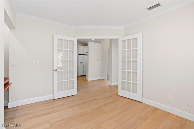 unfurnished room with light hardwood / wood-style flooring, crown molding, and french doors