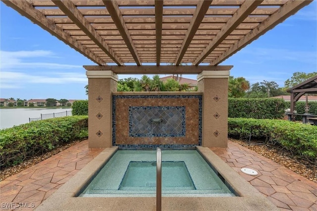 exterior space featuring a pergola and an in ground hot tub