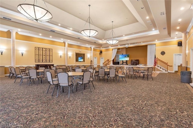 dining area with a raised ceiling and a notable chandelier