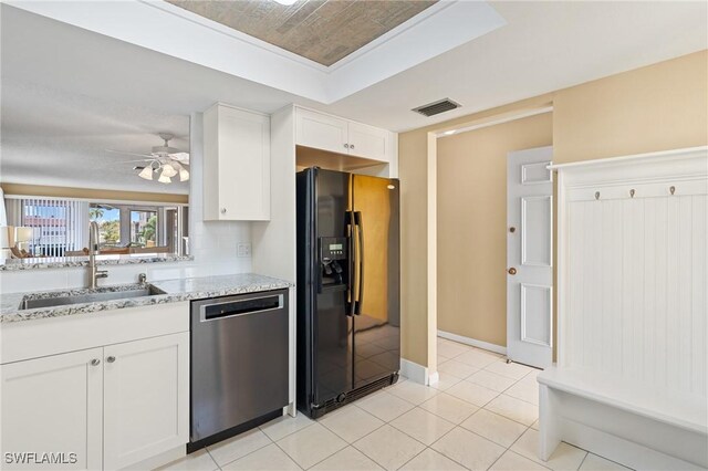 kitchen with sink, stainless steel dishwasher, light stone countertops, black fridge with ice dispenser, and white cabinetry