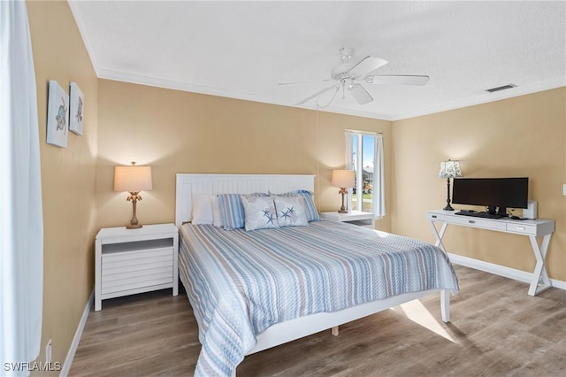 bedroom with hardwood / wood-style floors, ceiling fan, and crown molding