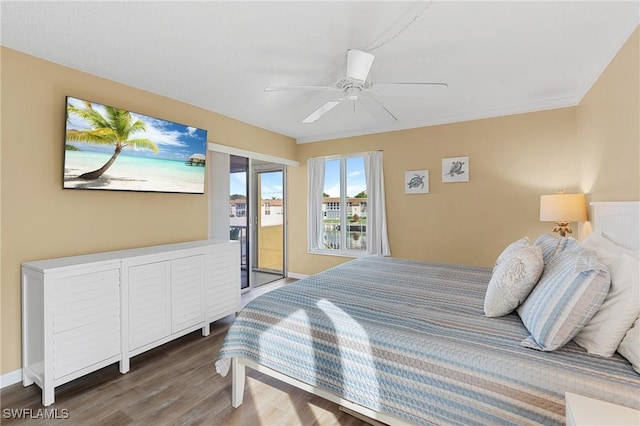 bedroom featuring ceiling fan, dark hardwood / wood-style floors, and access to exterior