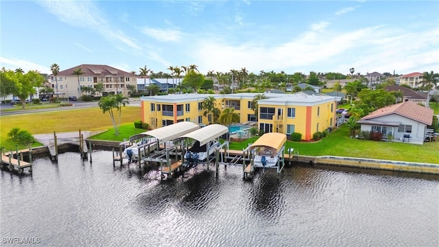 exterior space with a water view and a lawn