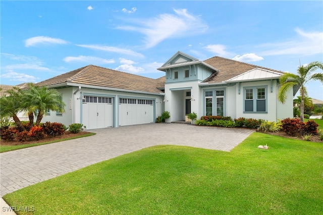 view of front facade featuring a garage and a front lawn