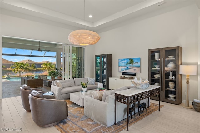 living room with ceiling fan and light hardwood / wood-style flooring