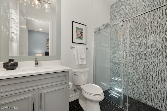 bathroom with tile patterned flooring, vanity, toilet, and a shower with shower door