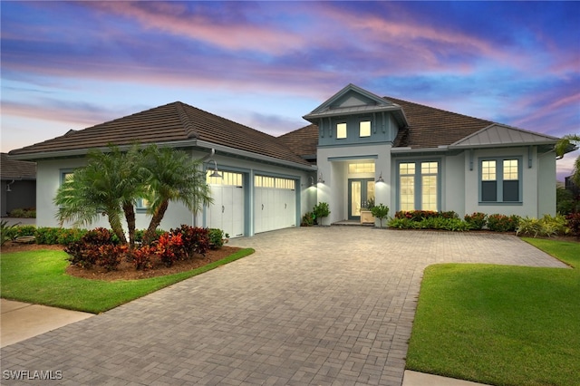 view of front of house with a yard and a garage