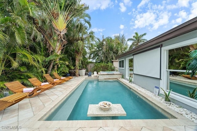 view of pool with a hot tub