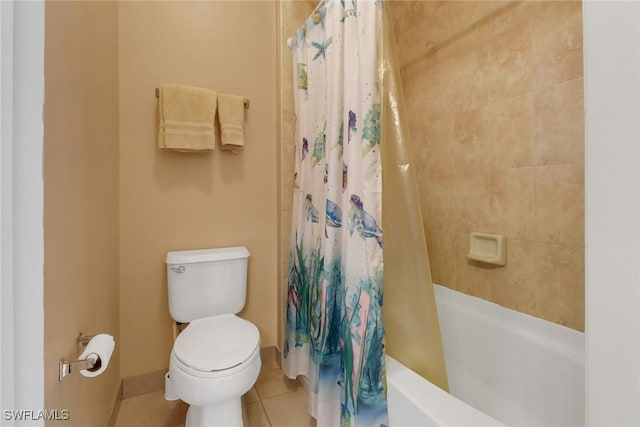 bathroom with tile patterned floors, shower / tub combo with curtain, and toilet