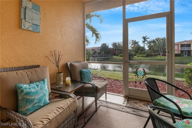 sunroom / solarium featuring a water view and a healthy amount of sunlight