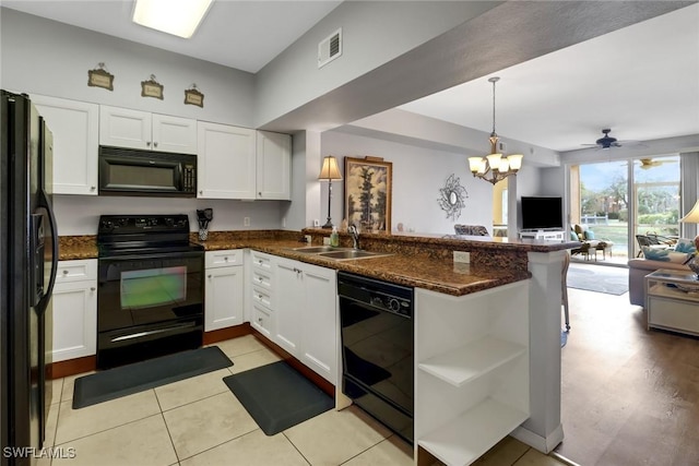 kitchen featuring kitchen peninsula, ceiling fan with notable chandelier, sink, black appliances, and white cabinets