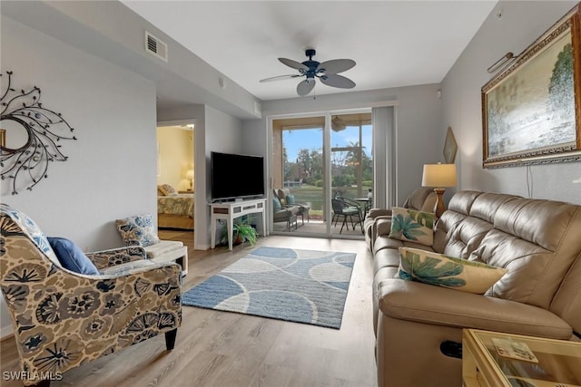 living room featuring ceiling fan and light wood-type flooring