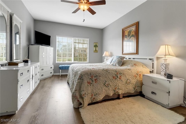 bedroom with hardwood / wood-style flooring and ceiling fan