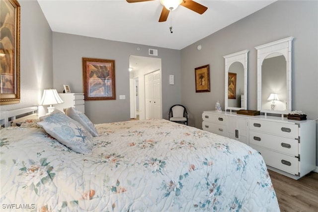 bedroom with ceiling fan, a closet, and light hardwood / wood-style floors