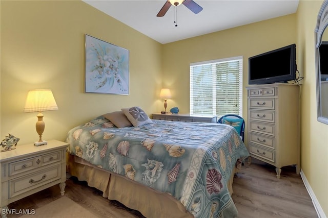 bedroom with ceiling fan and light hardwood / wood-style floors