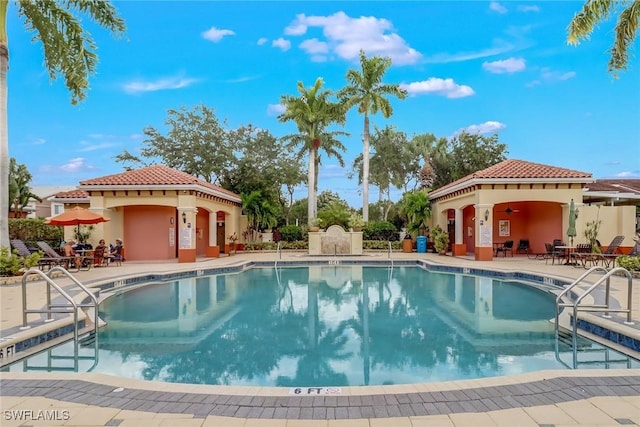 view of pool with a patio and ceiling fan