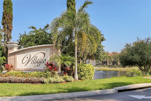 community / neighborhood sign with a water view