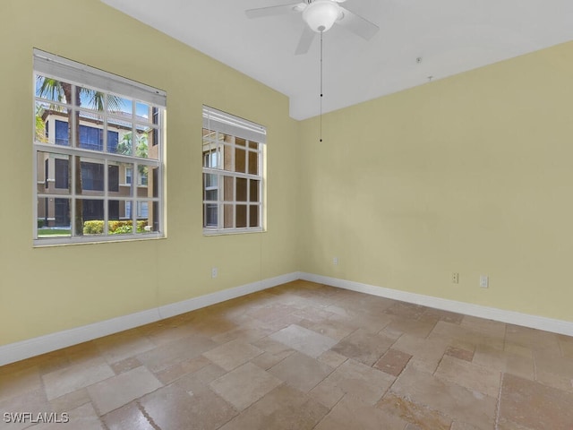 unfurnished room featuring ceiling fan and a healthy amount of sunlight