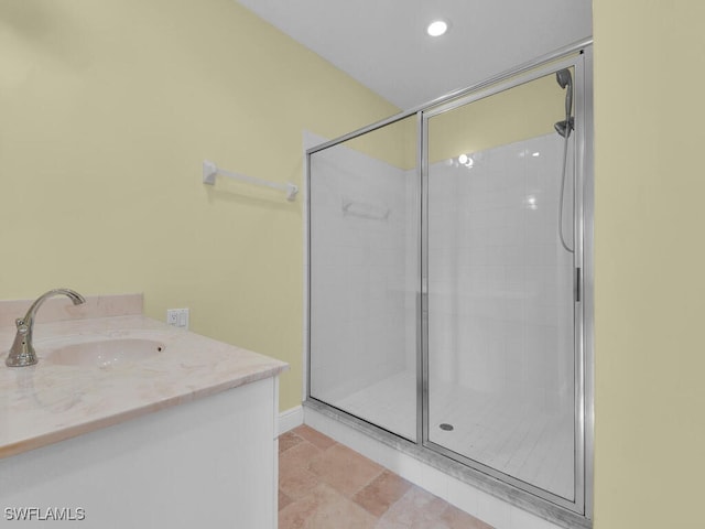 bathroom featuring vanity and a shower with door