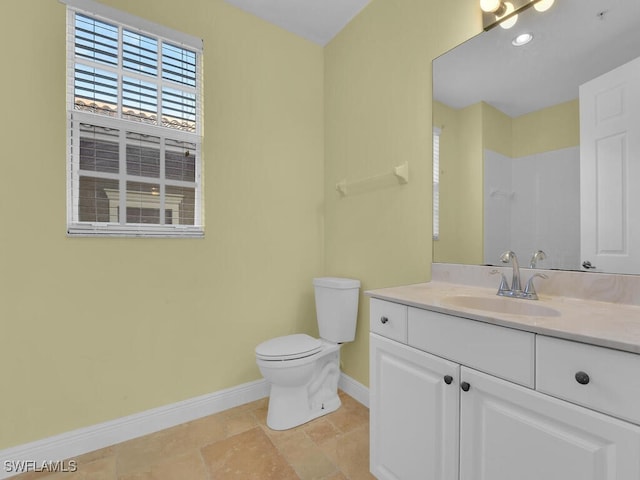 bathroom featuring tile patterned flooring, vanity, toilet, and a shower