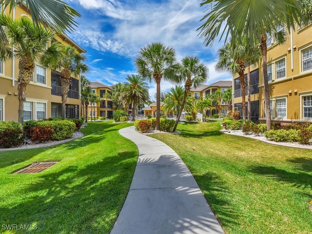 view of home's community with a yard