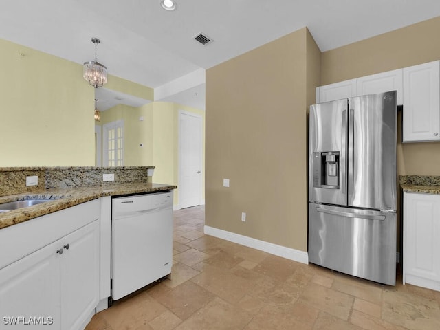 kitchen featuring white cabinetry, stainless steel fridge with ice dispenser, dishwasher, and dark stone counters