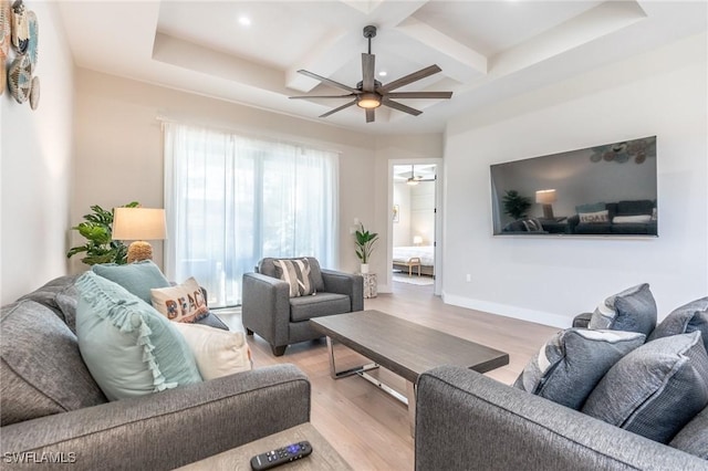 living room featuring beam ceiling, ceiling fan, coffered ceiling, and light wood-type flooring