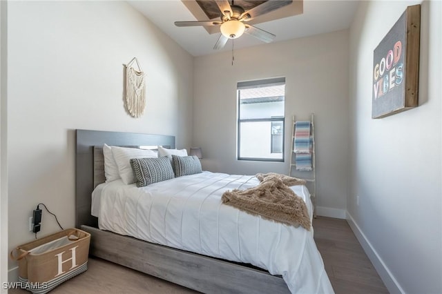 bedroom with ceiling fan and wood-type flooring