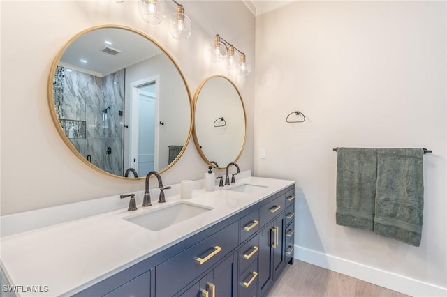 bathroom featuring hardwood / wood-style floors, vanity, and walk in shower