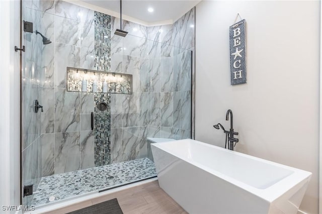 bathroom featuring independent shower and bath and wood-type flooring