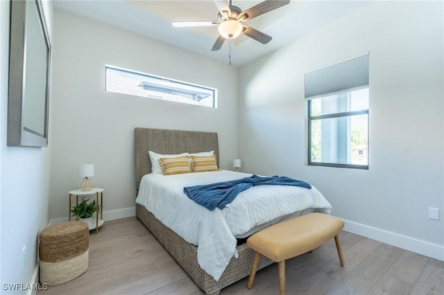 bedroom with ceiling fan and light wood-type flooring