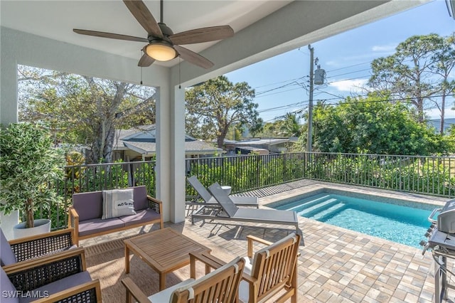 view of swimming pool featuring an outdoor living space, ceiling fan, and a patio area