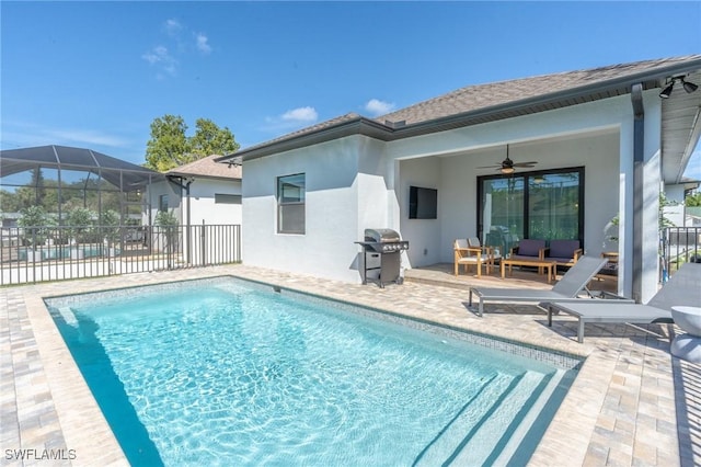 view of pool with ceiling fan, a grill, a lanai, and a patio