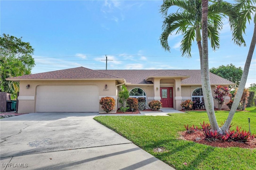 single story home featuring a front yard and a garage