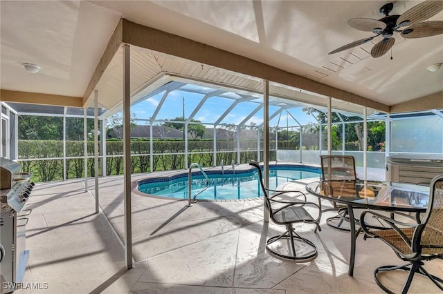 view of pool with ceiling fan, a lanai, a patio, and a hot tub