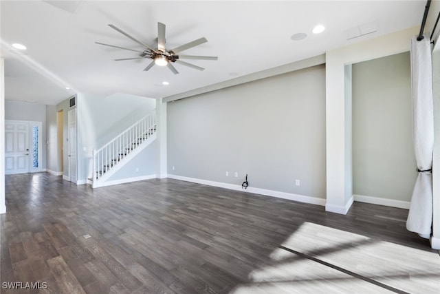 unfurnished living room featuring dark hardwood / wood-style floors and ceiling fan