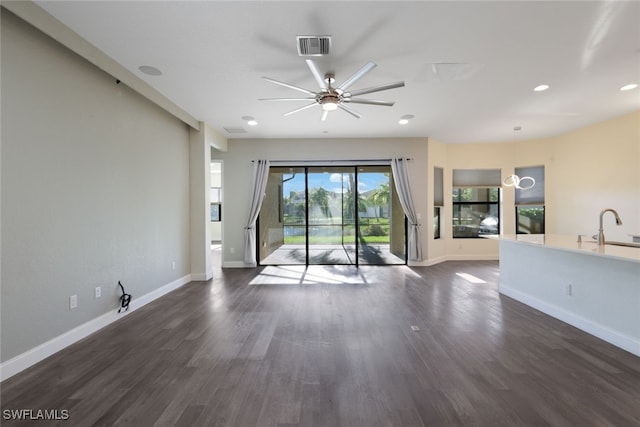 spare room featuring ceiling fan, sink, and dark wood-type flooring