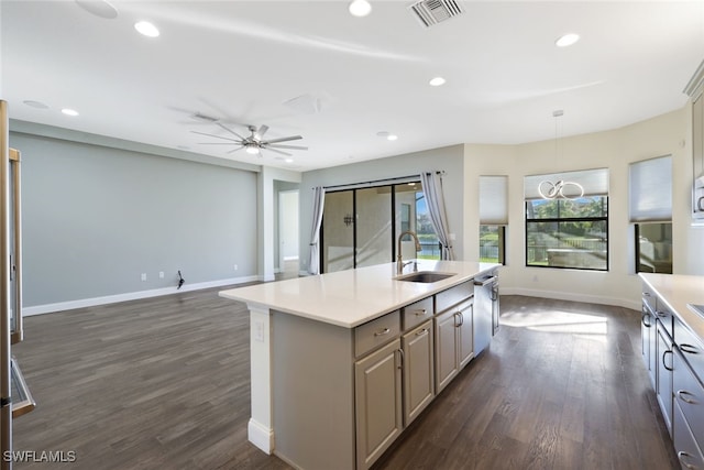 kitchen with ceiling fan, sink, dark hardwood / wood-style flooring, an island with sink, and decorative light fixtures