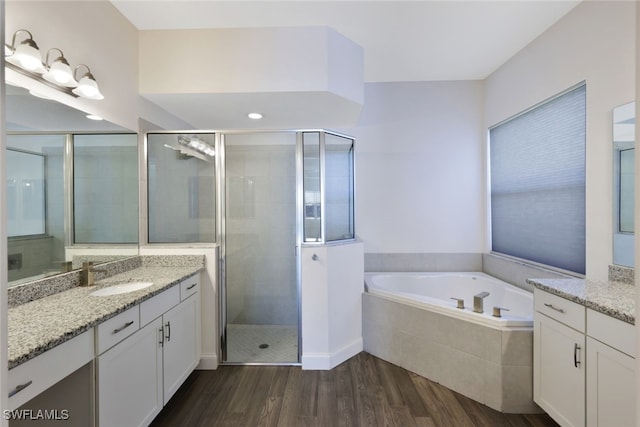 bathroom with separate shower and tub, vanity, and wood-type flooring