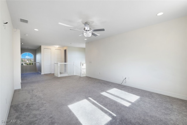 carpeted spare room with ceiling fan