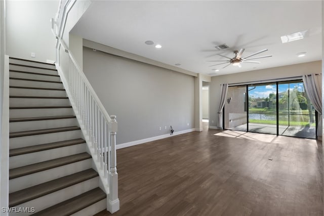 unfurnished living room with ceiling fan and dark hardwood / wood-style flooring