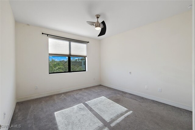 spare room featuring ceiling fan and carpet floors