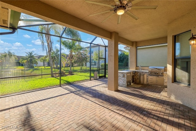 unfurnished sunroom featuring ceiling fan