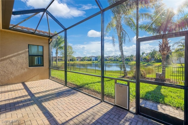 unfurnished sunroom with a water view