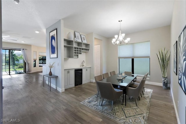 11727 Kati Falls Ln, Fort Myers, FL 33913 - dining area with dark wood finished floors, ceiling fan with notable chandelier, baseboards, and beverage cooler
