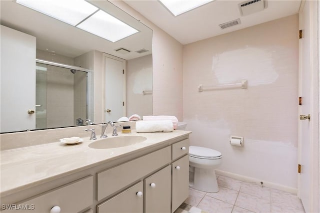 bathroom featuring tile patterned flooring, a shower with door, vanity, and toilet