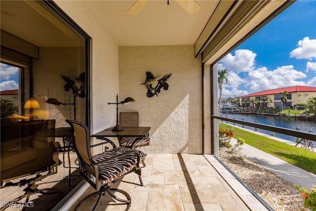 sunroom / solarium with a water view