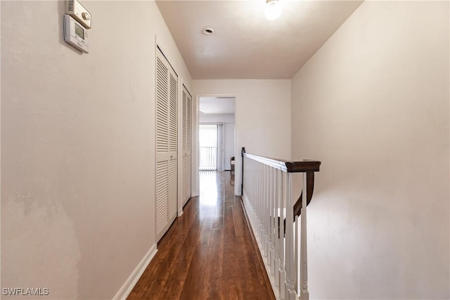 corridor featuring dark wood-type flooring