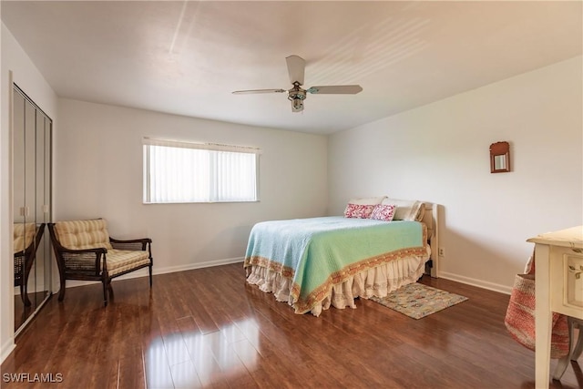 bedroom with dark hardwood / wood-style flooring and ceiling fan